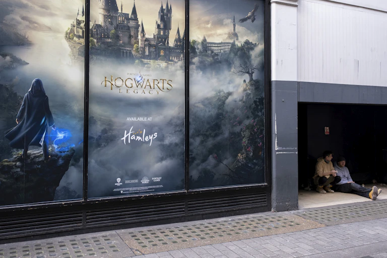 A large billboard displays a castle surrounded by clouds.
