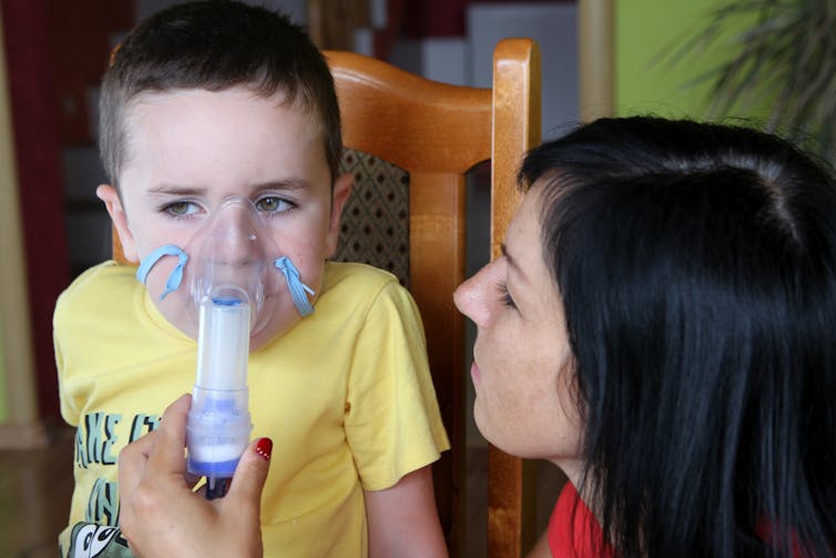 Mother gives child asthma medicine