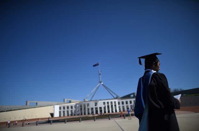 A graduate in the forecourt of Parliament House in Canberra.