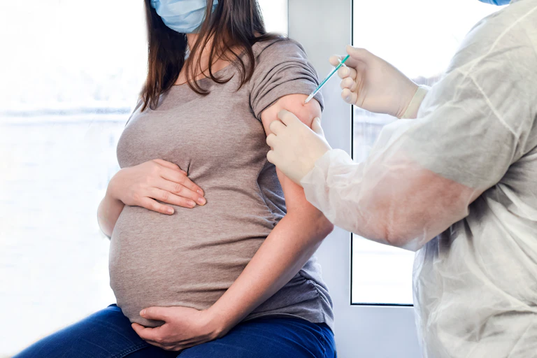 pregnant person gets injection in arm