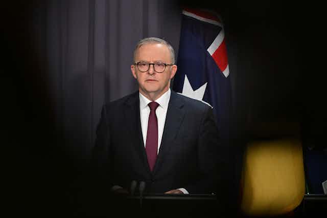 Anthony Albanese in front of Australian flag