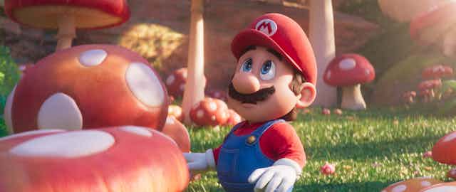 An animated character surrounded by giant mushrooms. 