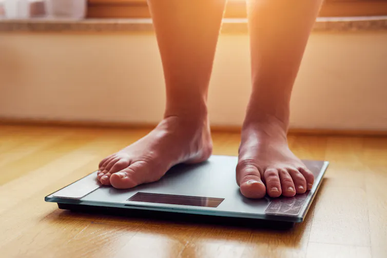 Feet standing on a scale.