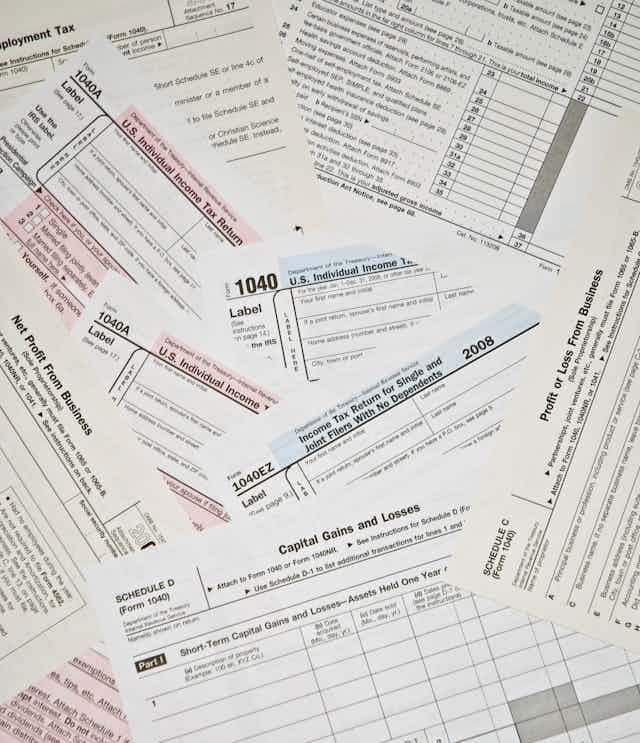 Scattered pile of black U.S. tax forms