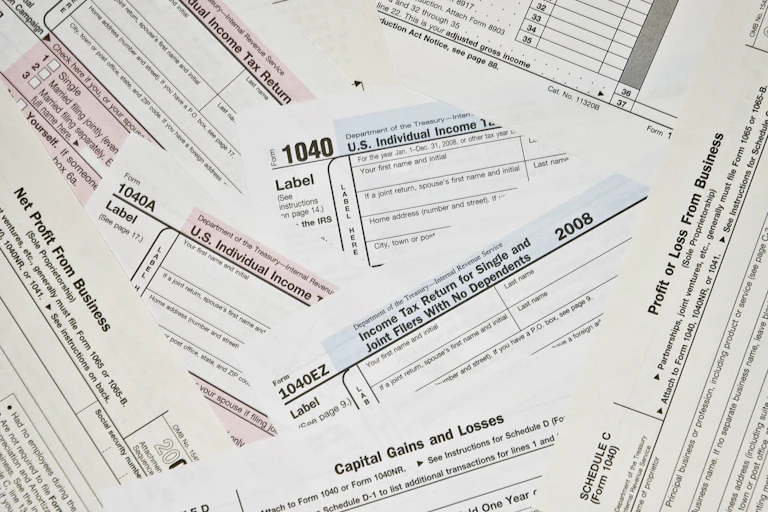 Scattered pile of black U.S. tax forms