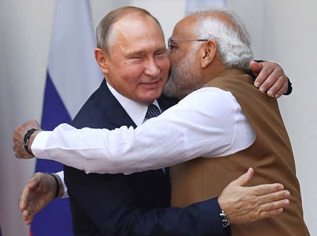 Two men, India's prime minister Modi and Russian president Putin hugging each other.