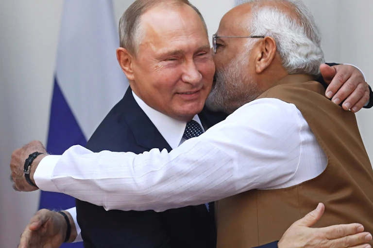 Two men, India's prime minister Modi and Russian president Putin hugging each other.
