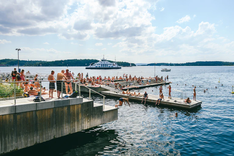 People swimming and sunbathing on a hot sunny summer day.