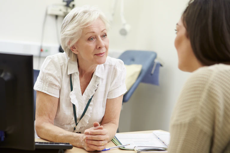 GP listens to patient