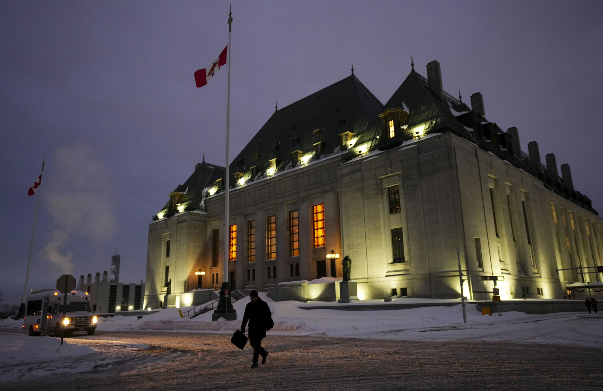 The Supreme Court building with the Canadian flag hoisted in from on it.