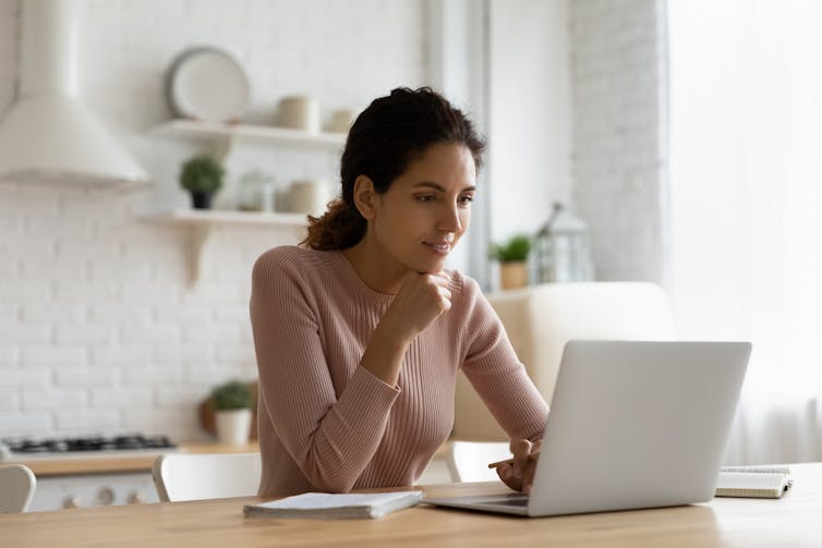 Woman looking at laptop screen