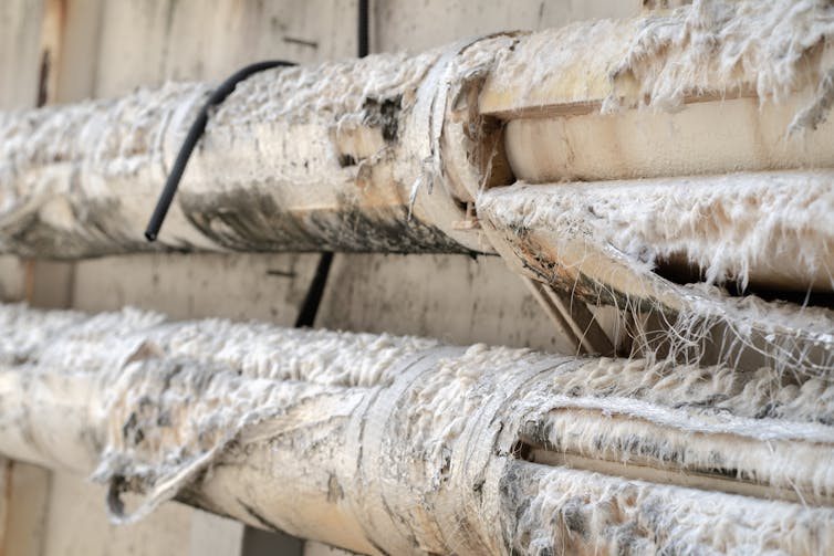 Pipes surrounded by asbestos insulation.