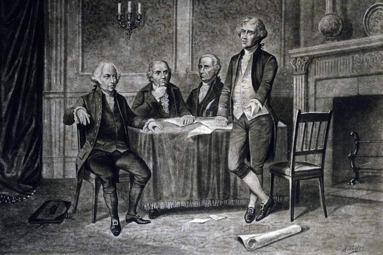 Four older men of the 18th century, around a table.