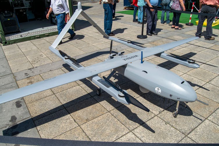 A military drone on a pavement.