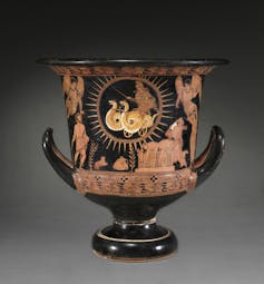 A black bowl from 400 B.C.E. with several figures painted on it.