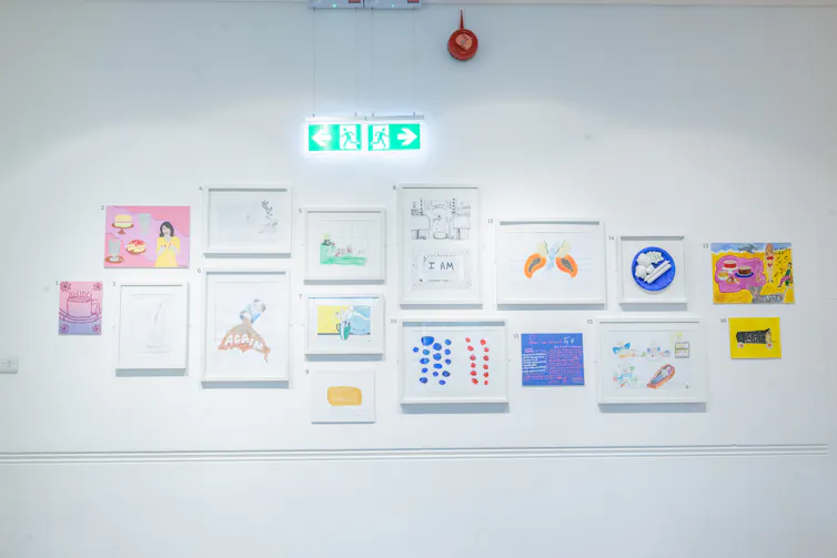 Art works framed on a white wall.