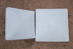 A 15-inch-square base used in 2022 is on the left, while an 18-inch-square base being used in 2023 is on the right