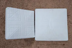 A 15-inch-square base used in 2022 is on the left, while an 18-inch-square base being used in 2023 is on the right
