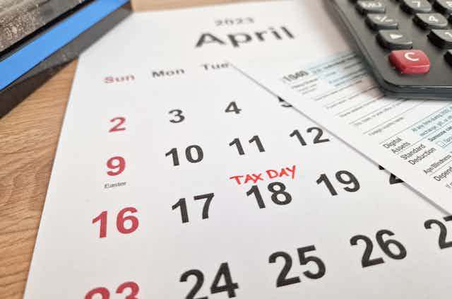 A calendar shows 'tax day' written over 18 in a calendar for April