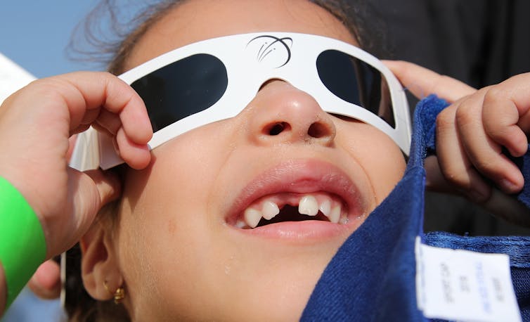 child in eclipse glasses