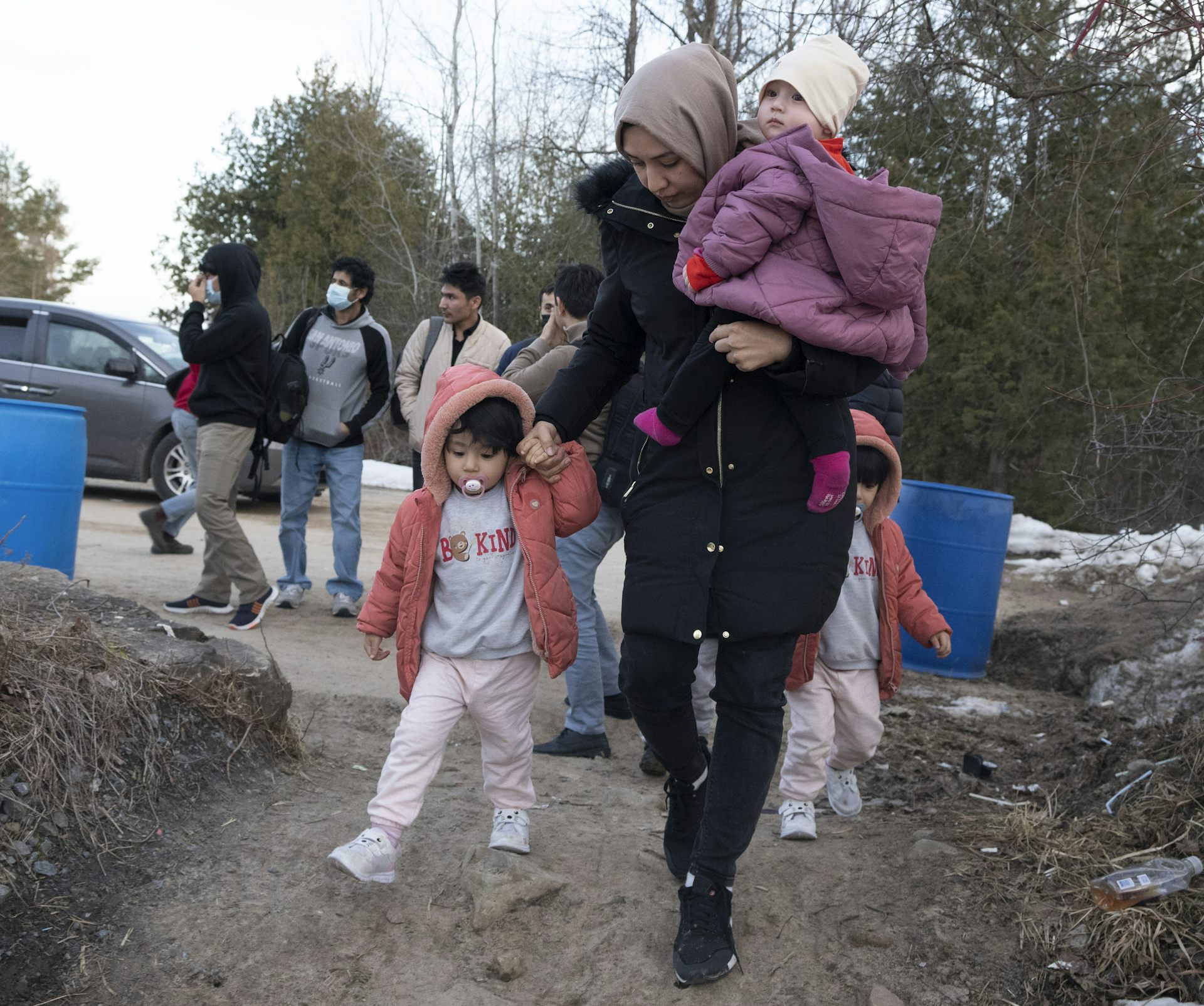 A person with two children wearing winter clothing