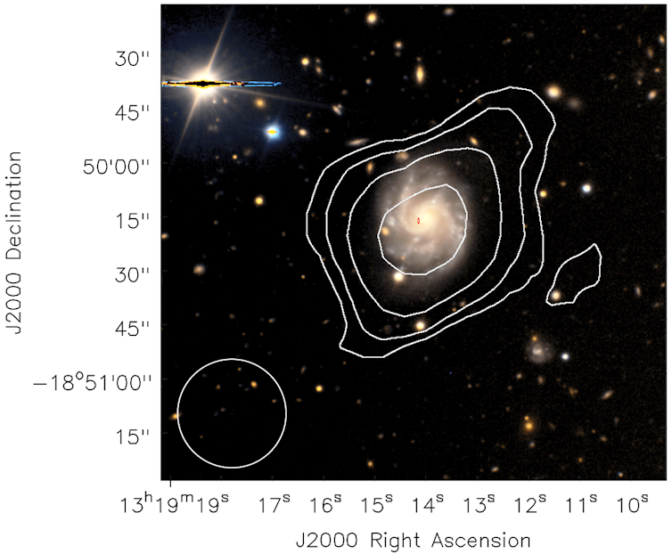 ASKAP both found the cold hydrogen gas (white contours) in this spiral galaxy, and pinpointed an FRB near the center (location given by the red ellipse).
