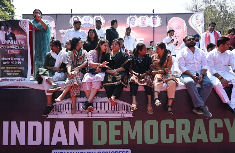Indian Youth Congress supporters with a sign reaqding: Indian Democracy