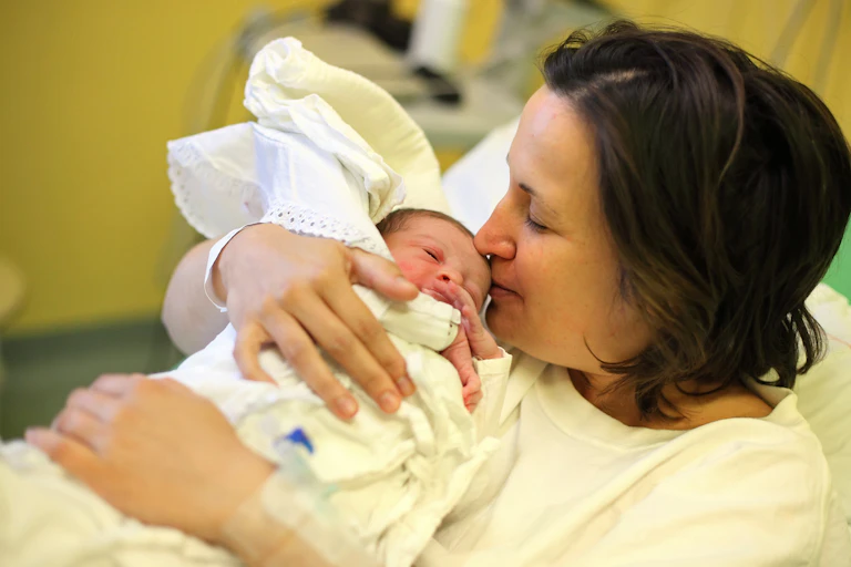 A new mother holding her baby