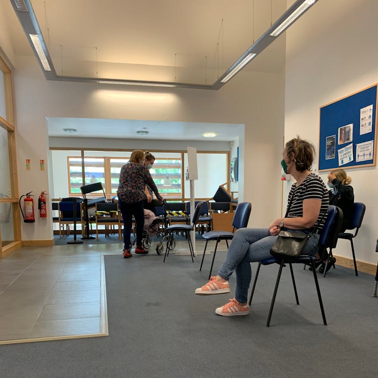 patients wait in a GP clinic waiting room