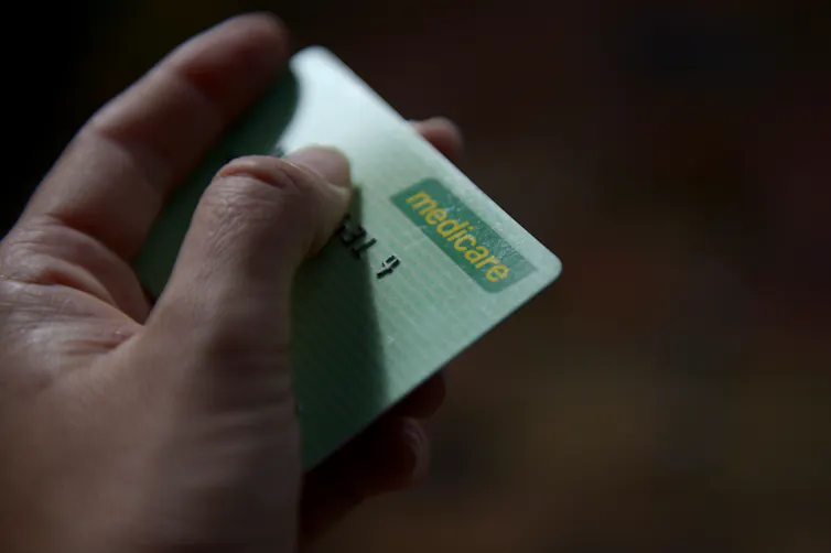 Person hands over Medicare card