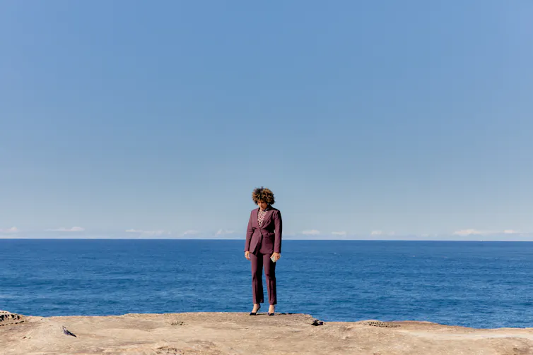 Zindzi Okenyo stands on the cliff edge.