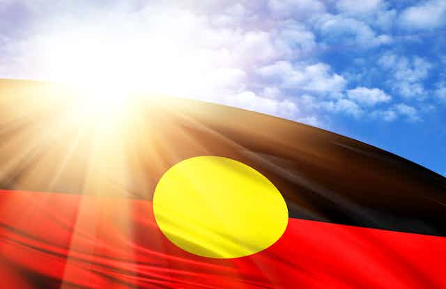 Aboriginal flag with sunshine in background
