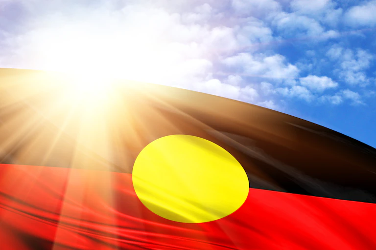 Aboriginal flag with sunshine in background