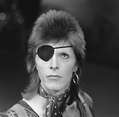 David Bowie with eyepatch and mullet.