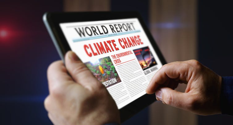 tablet showing climate change news article