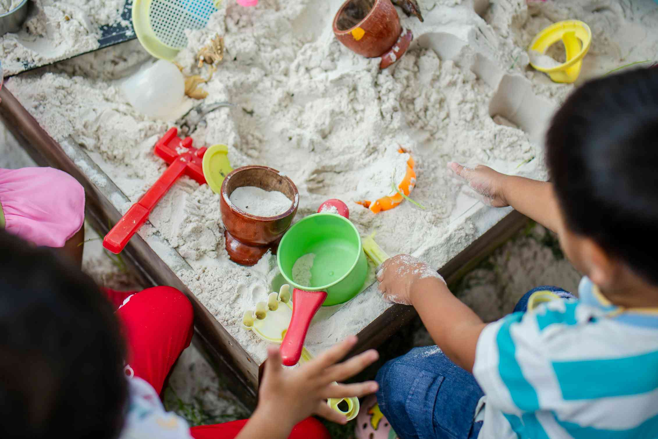Children seen with sand and toys.