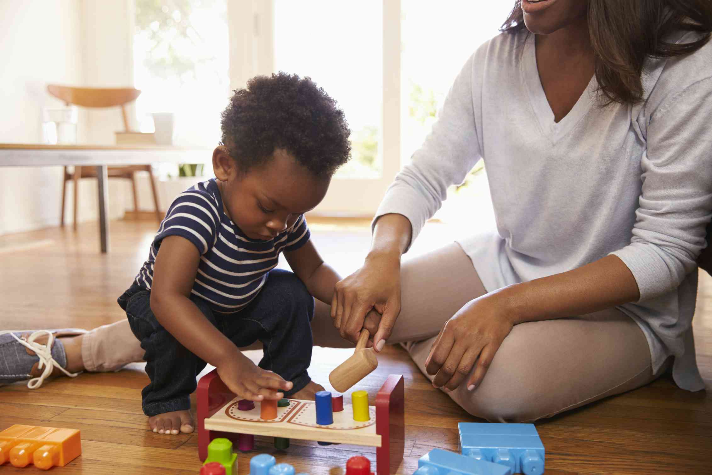 A toddler seen playing with blocks.
