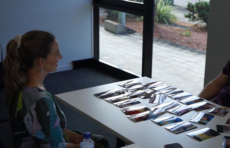 woman at table with photos on it