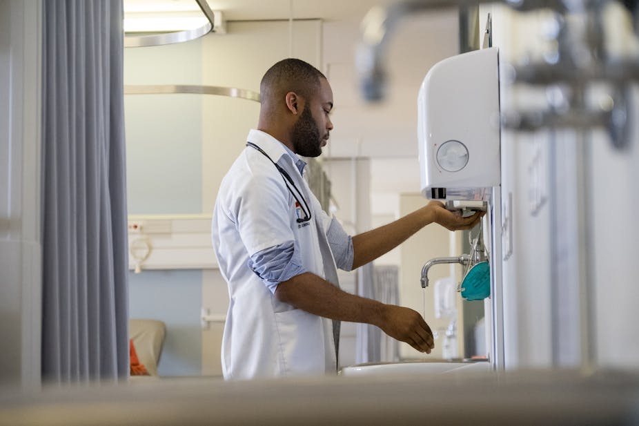An African healthcare worker washing his hands
