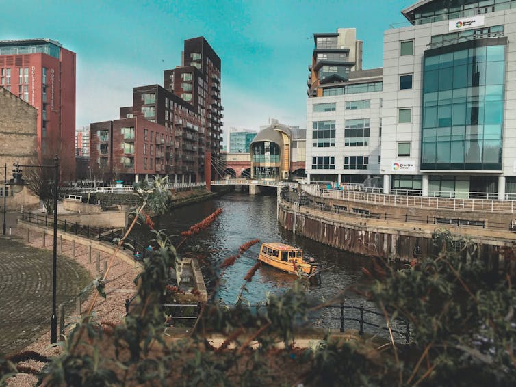 A yellow water taxi boat on the Leeds class=