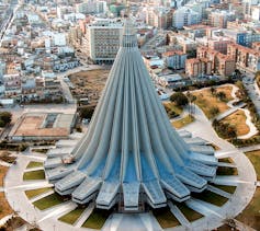 An unusual cathedral, shaped like an upside-down flower, seen from above.