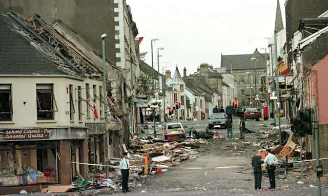 Policemen standing guarding a bombed street in Omagh, Northern Ireland I