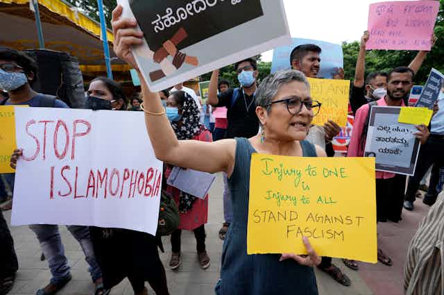 People at a protest with Stop Islamophobia signs.