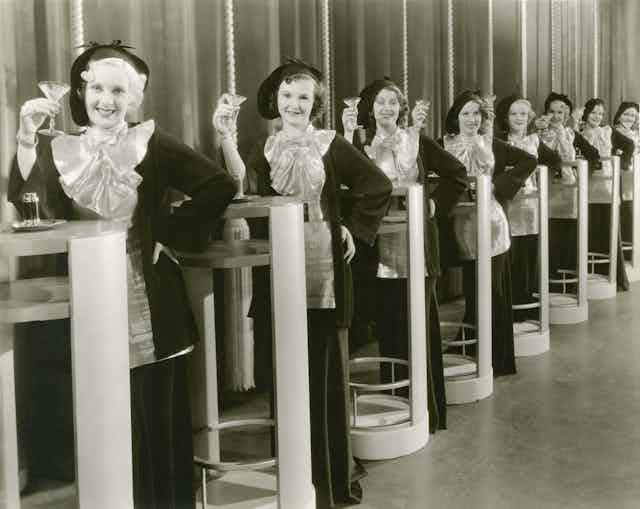 Line of women holding martinis