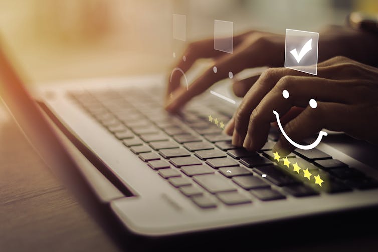 Person types on a laptop, superimposed images of smiley faces, stars and checkboxes.