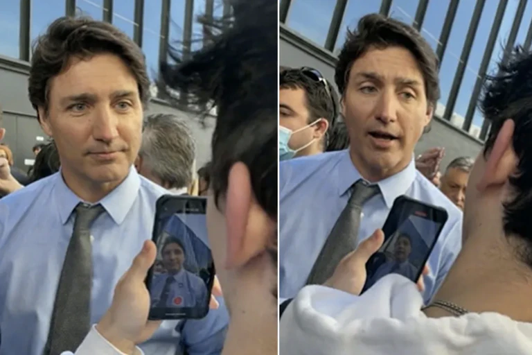A screengrab of a dark-haired man in a conversation with a student who is seen from behind.