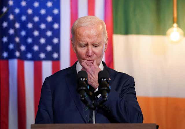 President Joe Biden in front of US and Irish flags.