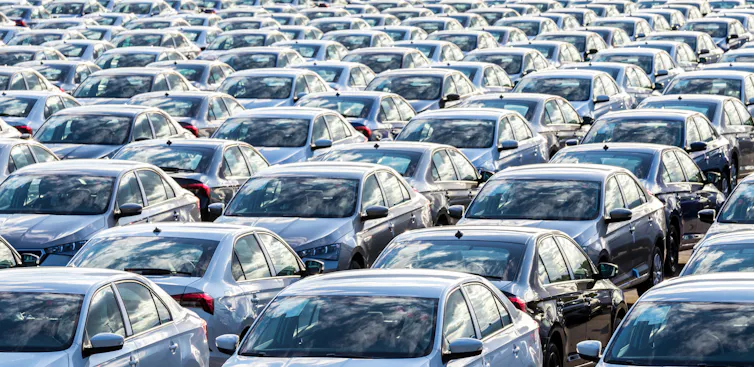 many new cars lined up in a row