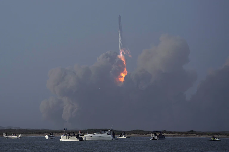 A rocket in the distance with a ball of fire and smoke below it.