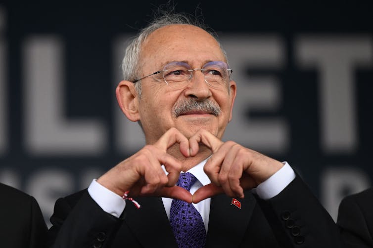 Turkish presidential candidate Kemal Kilicdaroglu makes a heart shape with his hands during a rally